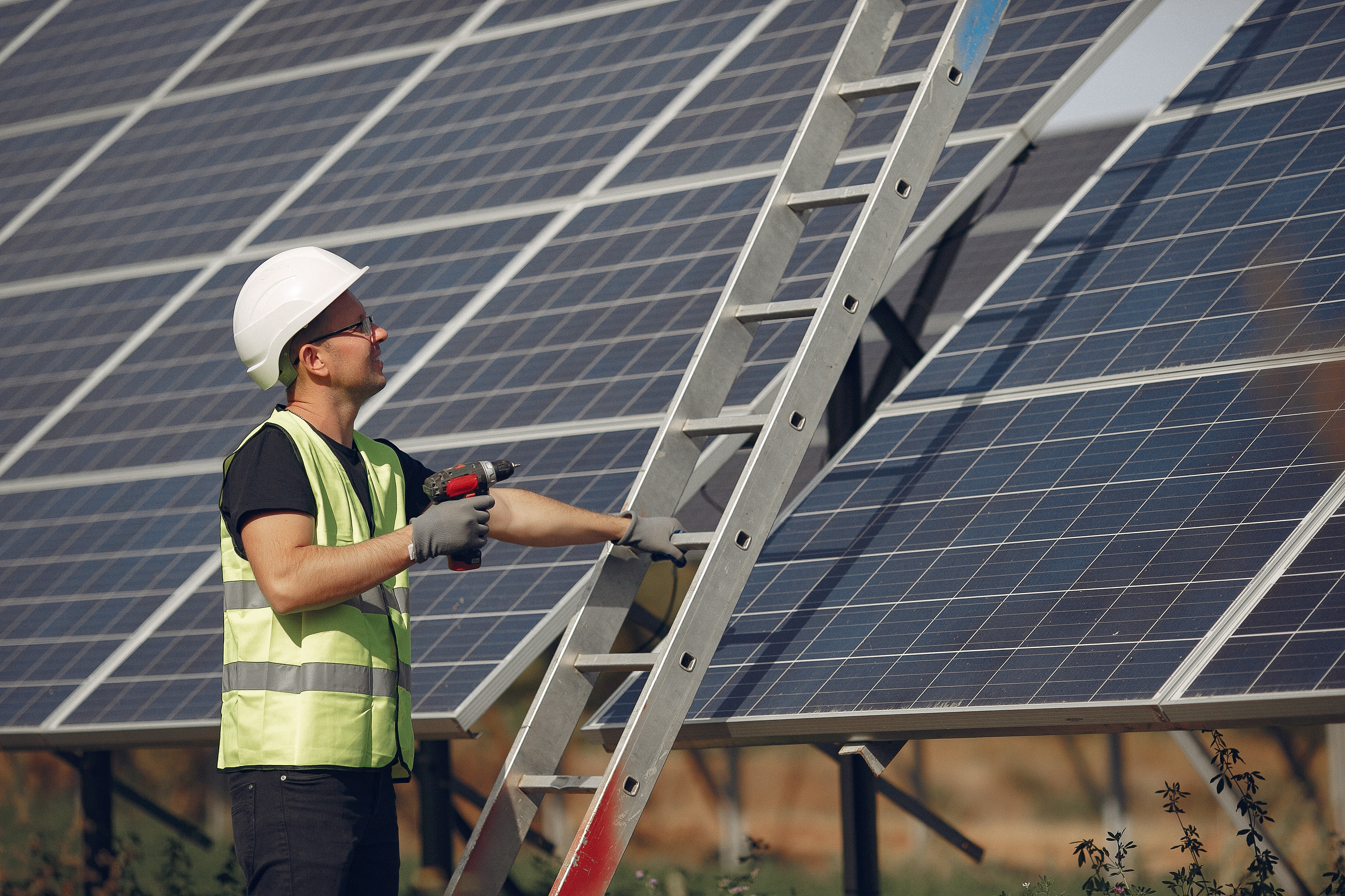 man-with-white-helmet-near-solar-panel(1)